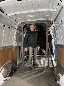 Jean Michel Bouyer in the frame of a truck